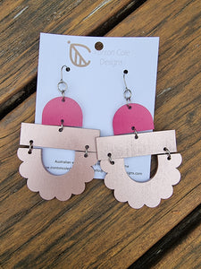 Our mega style earrings. A combination of three shapes with the top a hot pink arch, a metallic pink bar and a half flower metallic pink shape.  Hypoallergenic hooks. 
