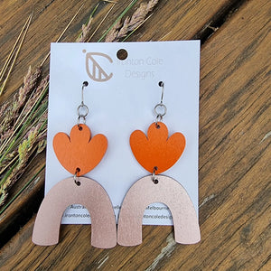 An orange painted flower petals paired with a bronze arch. Hypoallergenic silver hooks. 