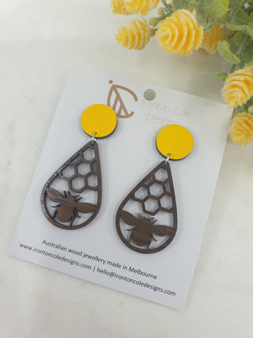 bee and honey comb earrings made from queensland walnut matched with a hand painted yellow disc.