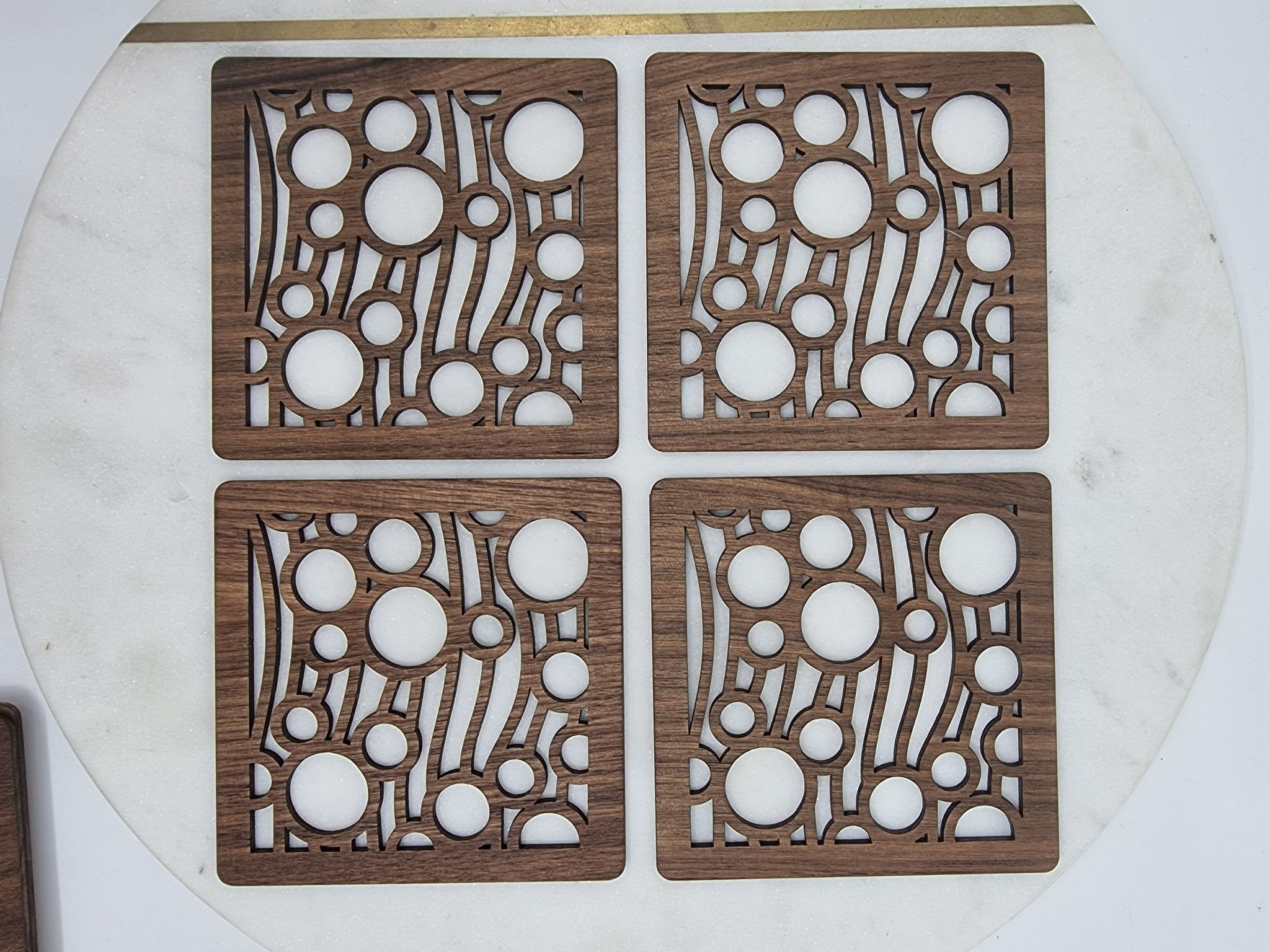 Square wooden coasters with cut out bubble shapes. 
