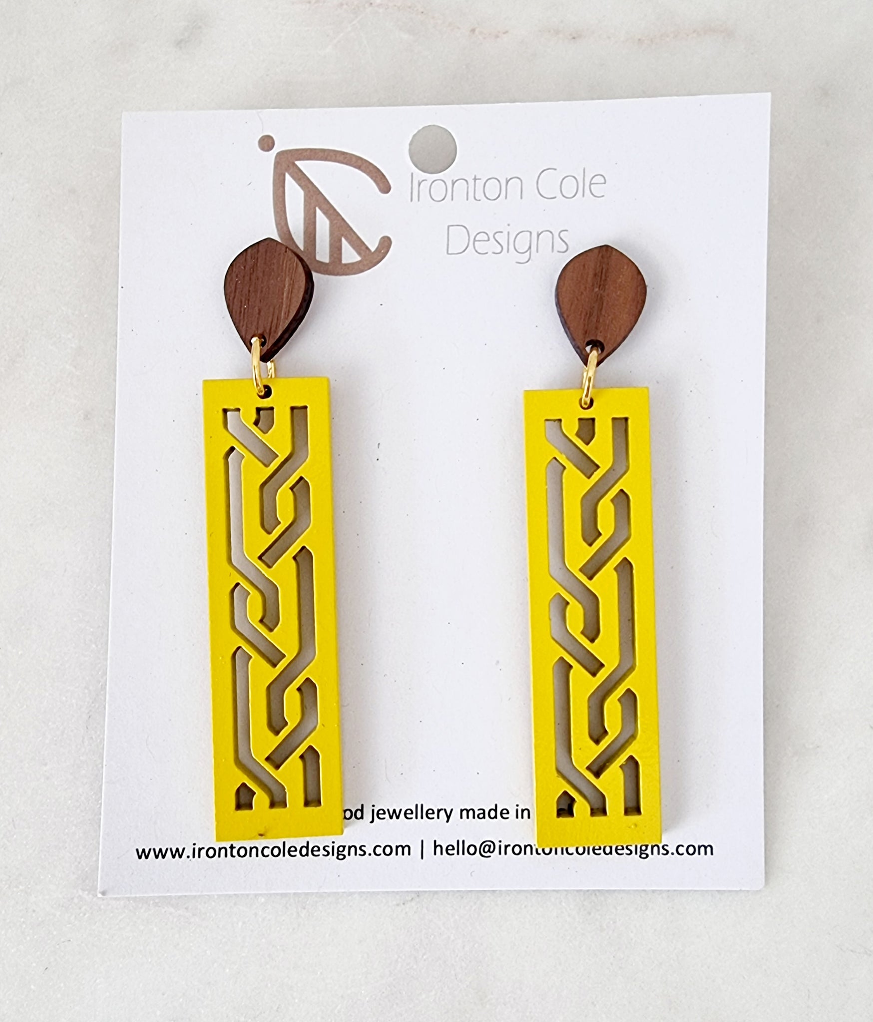 yellow wooden bar earrings with s laser cut designs