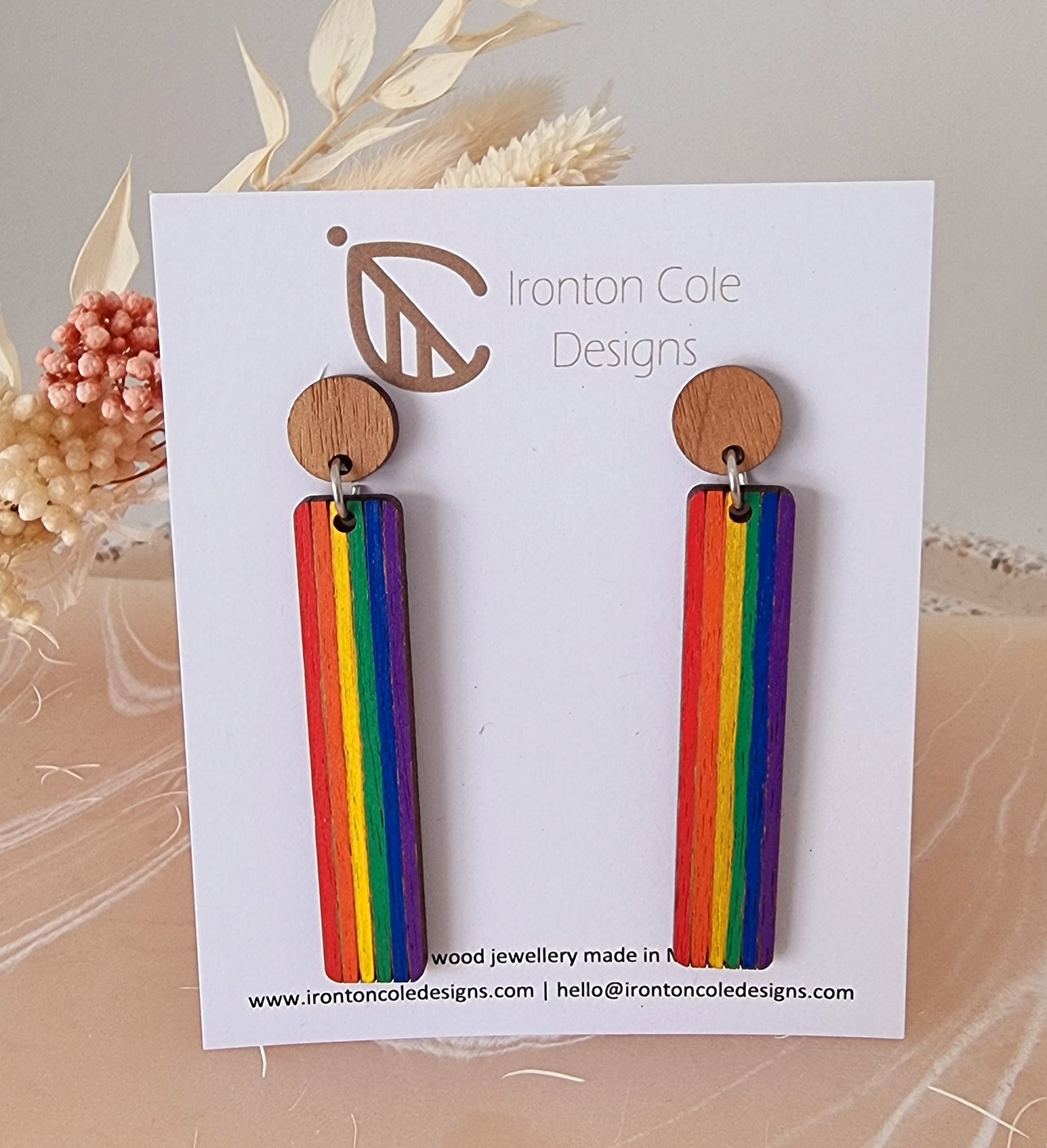 Rainbow pride wooden earrings in a bar shape.