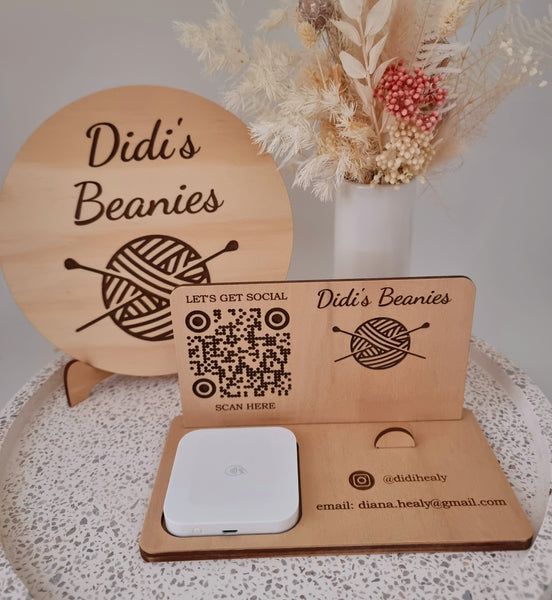 Round wooden sign with logo