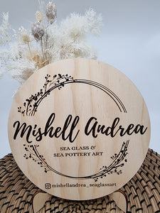 Round wooden sign with logo