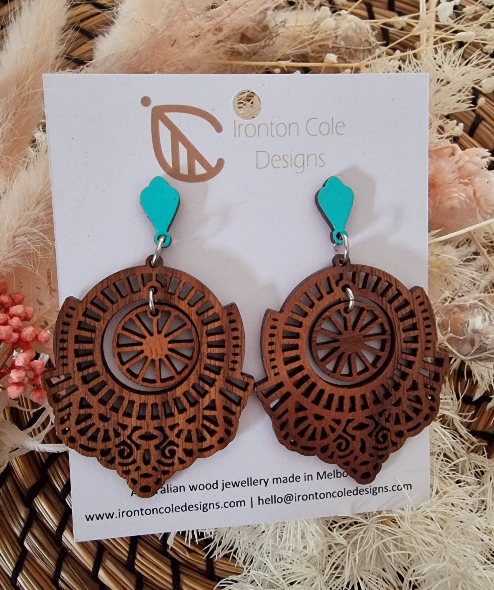 boho style wooden earrings. Wooden inner circle moves freely. The top pieces is a light baby blue colour. Hypoallergenic posts measures 7cm in length.