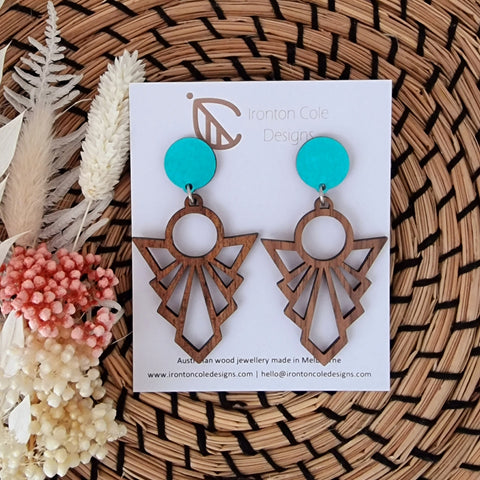 Wooden artdeco patterned earrings with a baby blue painted post. 